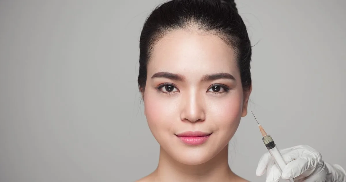 Injecting a woman's jawlinelower face, illustrating the precise application of dermal fillers for facial contouring