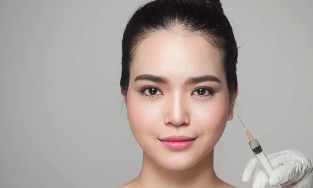 Injecting a woman's jawlinelower face, illustrating the precise application of dermal fillers for facial contouring