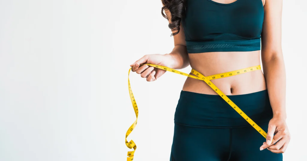 Woman measuring waist after MEDICAL WEIGHT LOSS progress check in Casa Grande, AZ