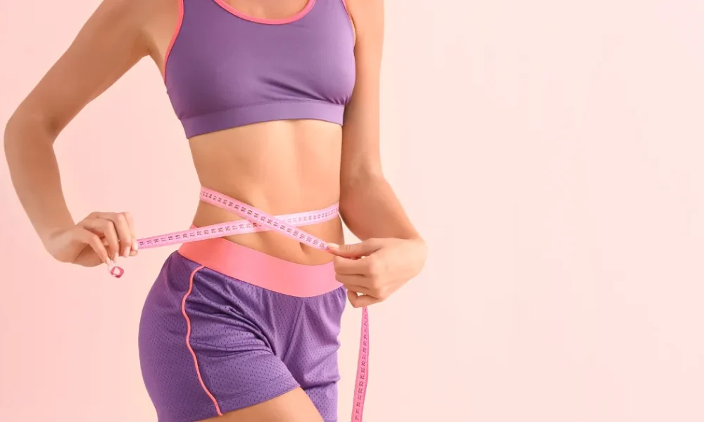 Women measuring waist after Medical weight loss program in Casa Grande, AZ